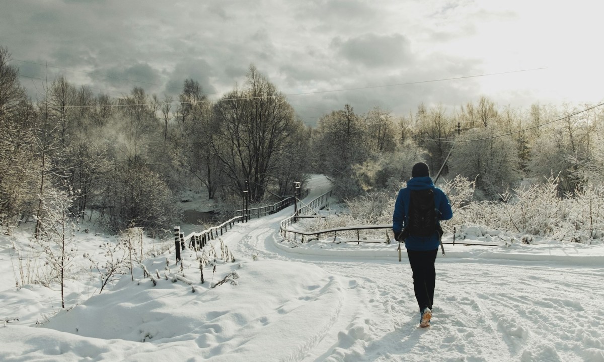 Man hiking in the winter on a snowy trail