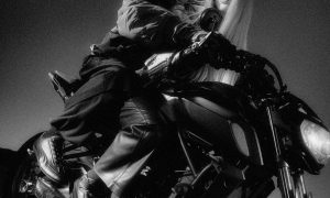 models on motorcycle in all black wearing speedcat sneakers