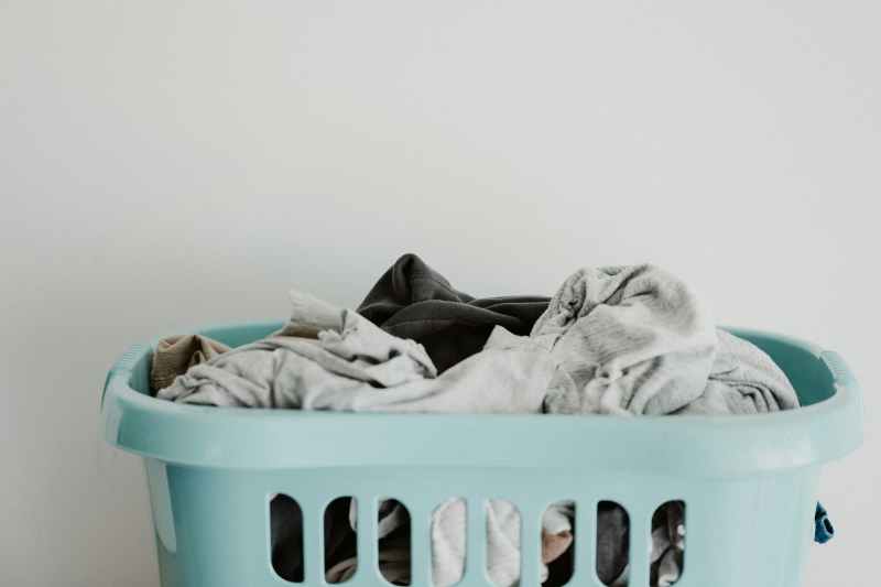 Dirty laundry in a blue basket