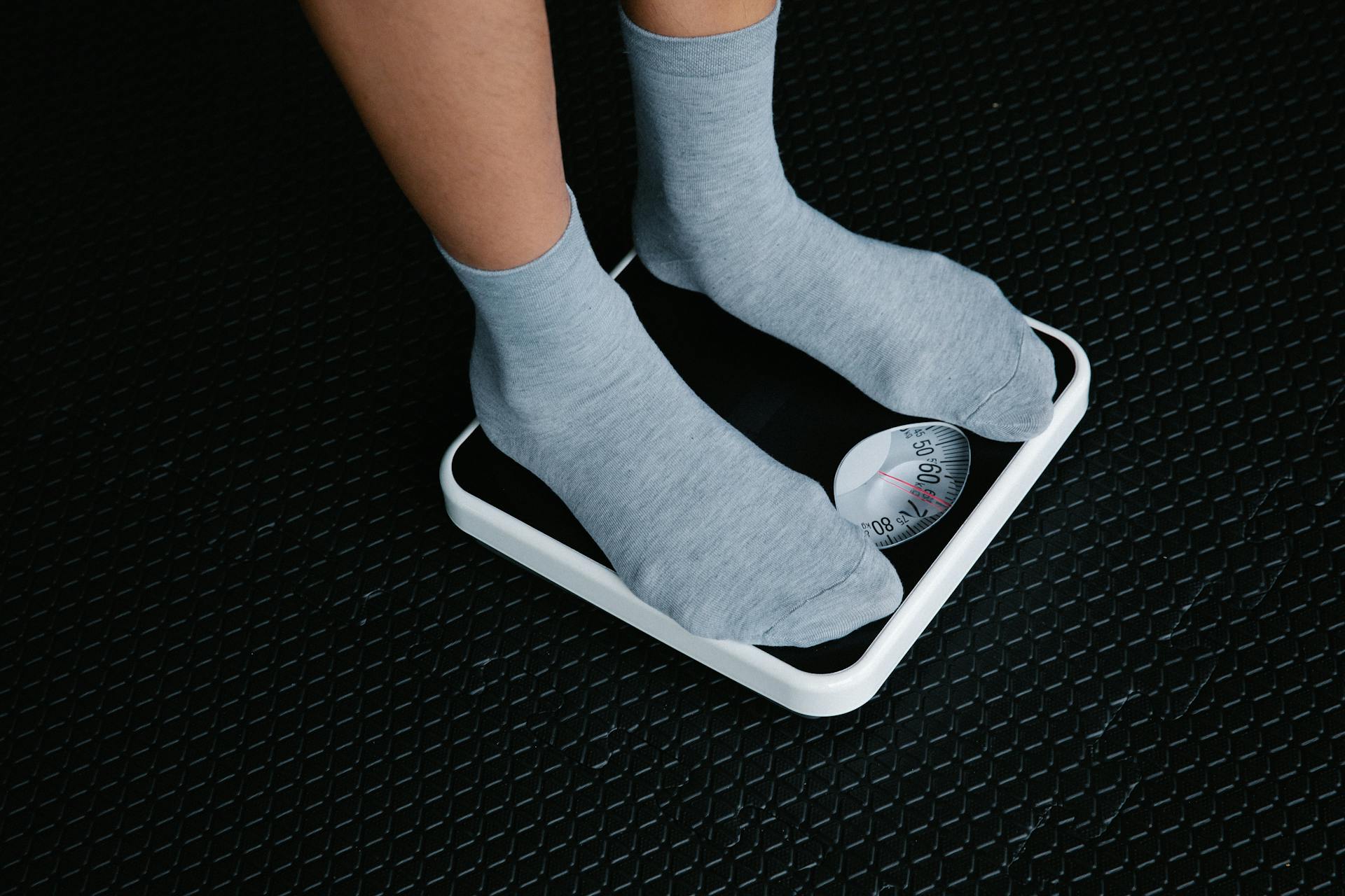 Standing on a scale weighing body weight