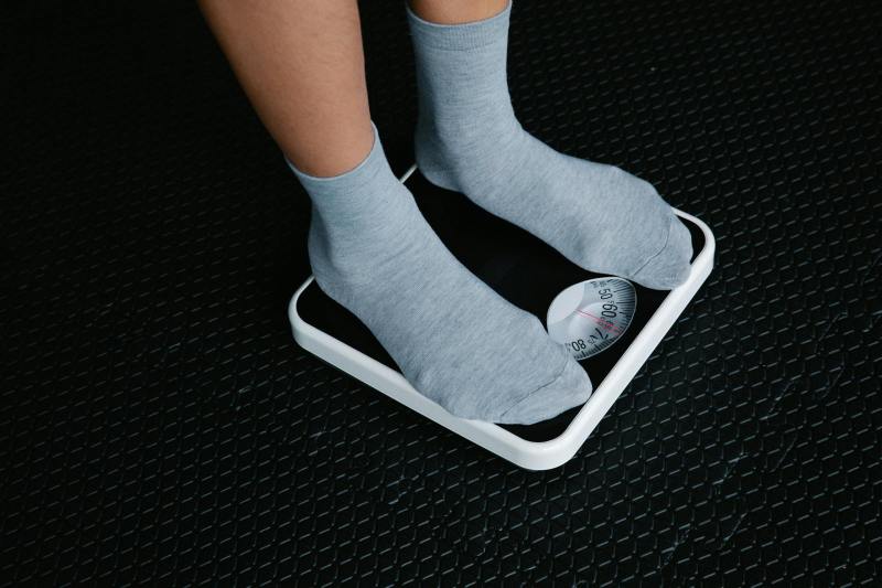 Standing on a scale weighing body weight