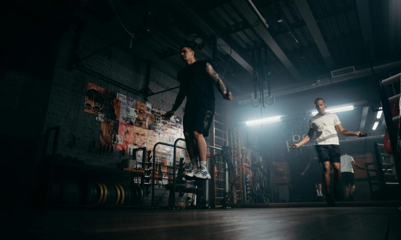 man jumping rope in gym jump rope aerobic cardio exercise