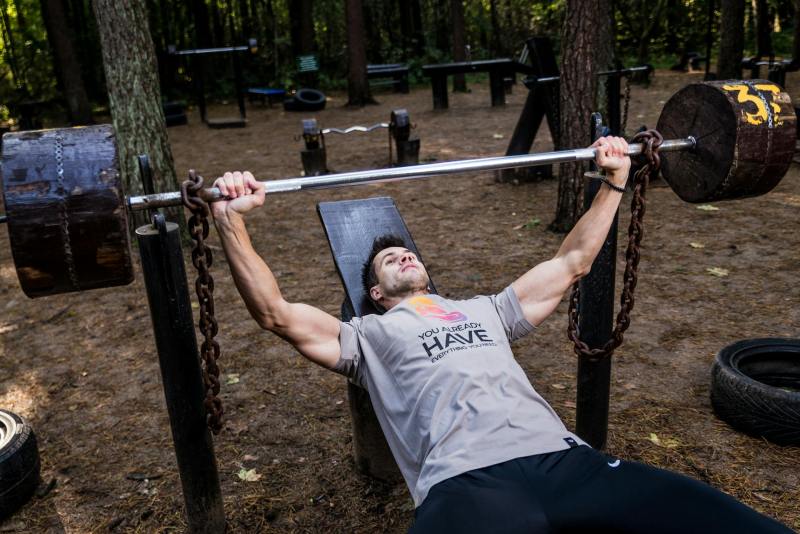 Man bench pressing outside