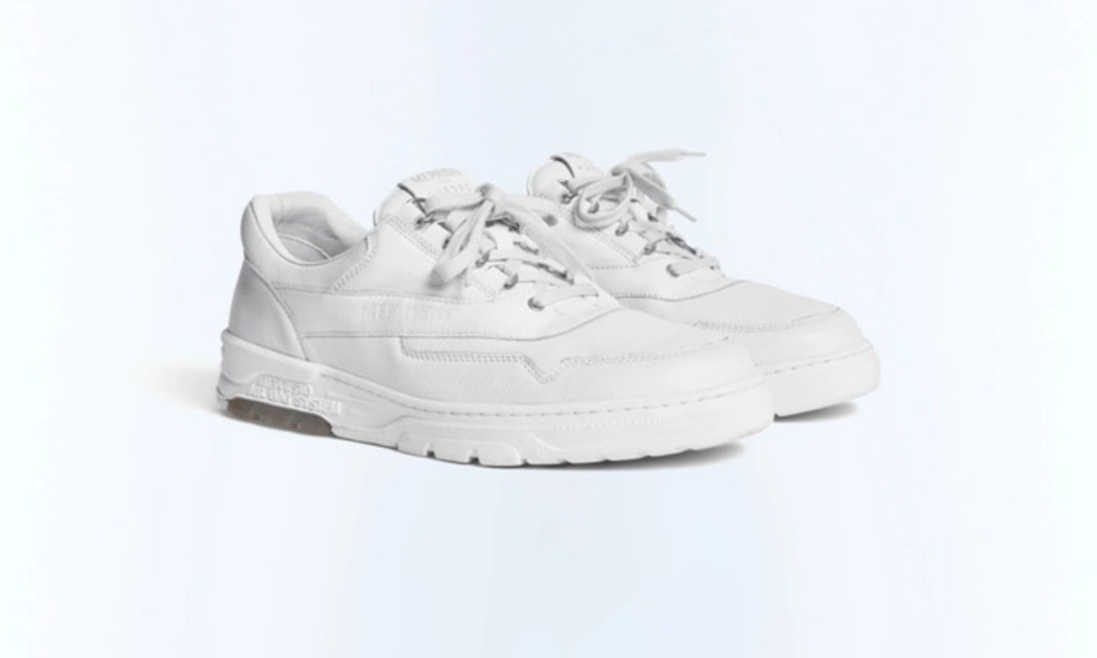 white sneakers in middle of blue light