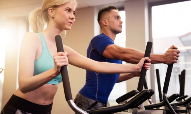 Man and woman using ellipticals