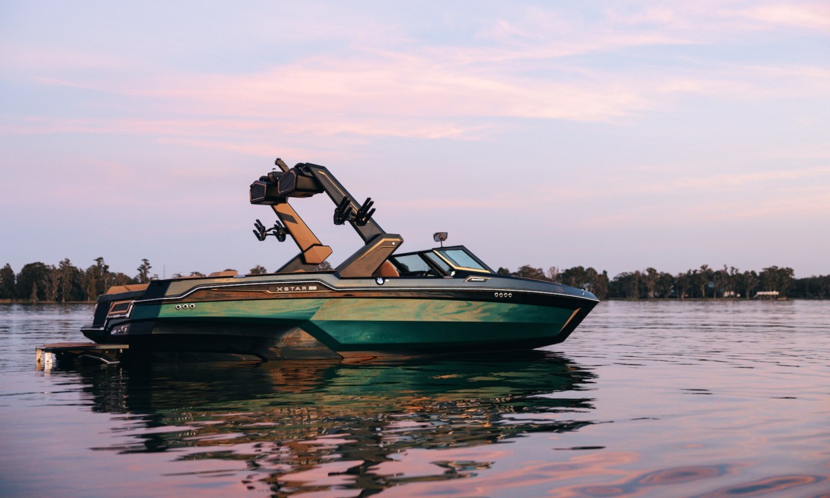 MasterCraft XStar X23 high performance wav and wakeboard boat on water right side view.