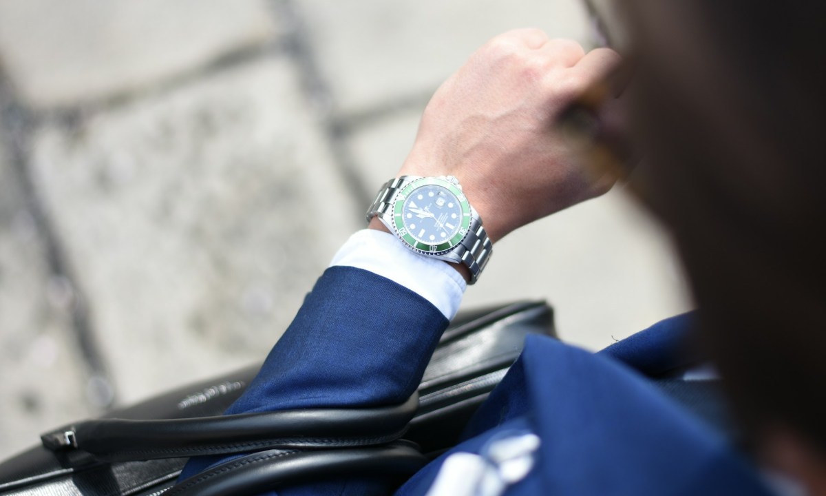 man with suit wearing a watch