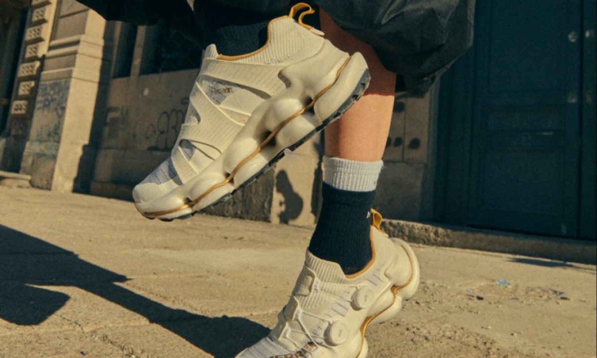 model wearing white merrell sneaker