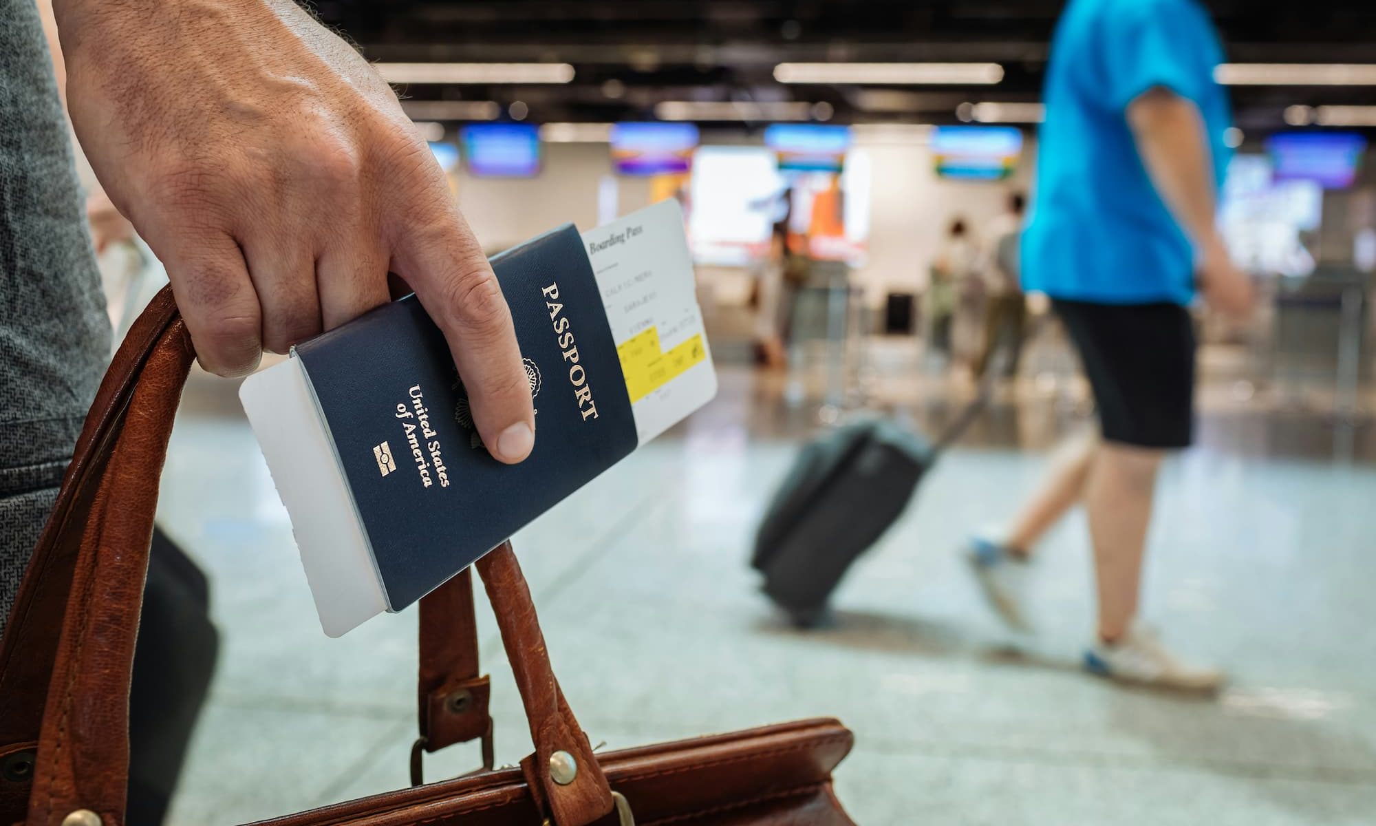 Man holding a passport in his hand at the airport