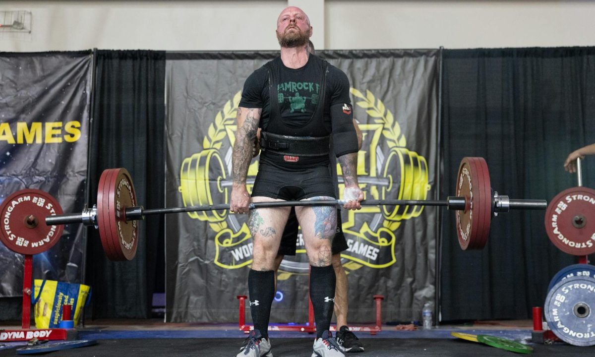 man powerlifting dead lift holding barbell competition