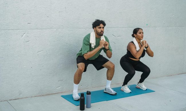 Two people doing squat exercises