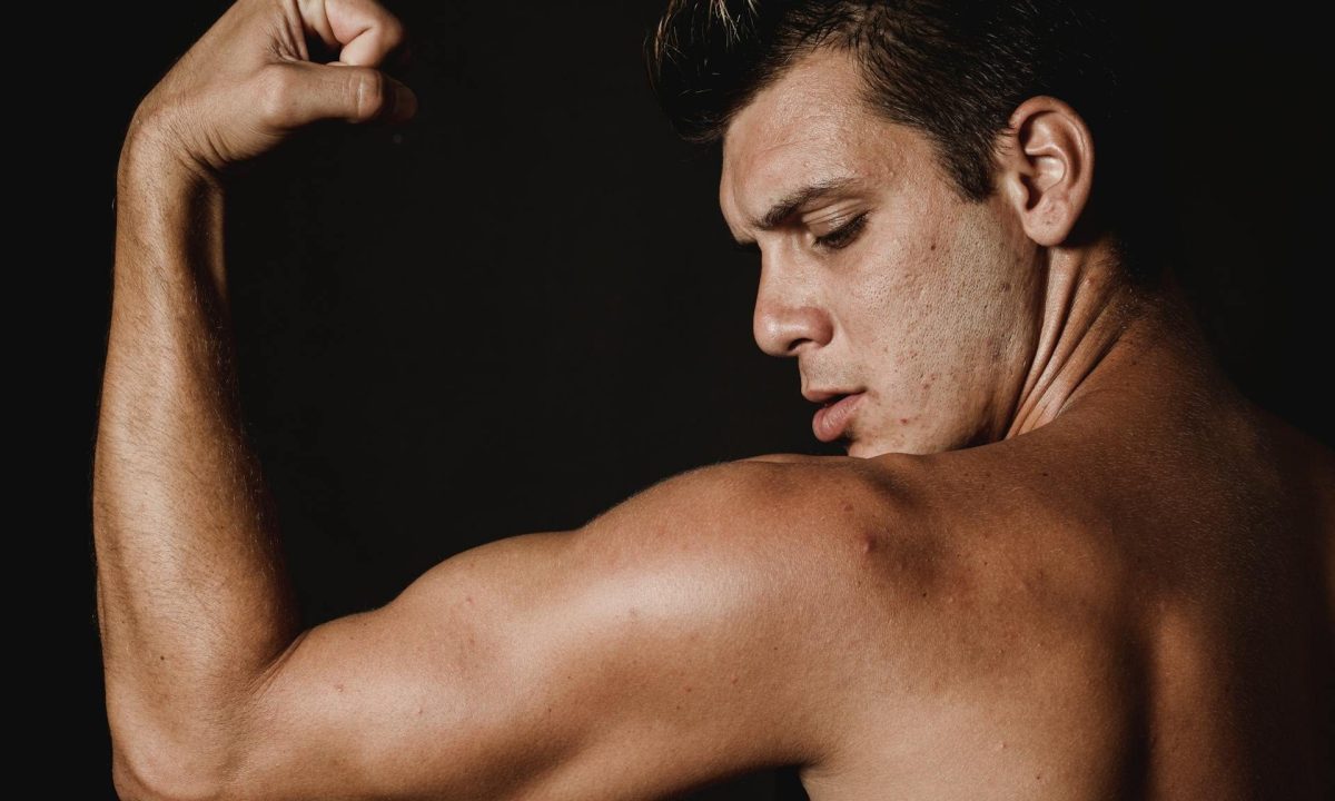 man flexing arms triceps biceps