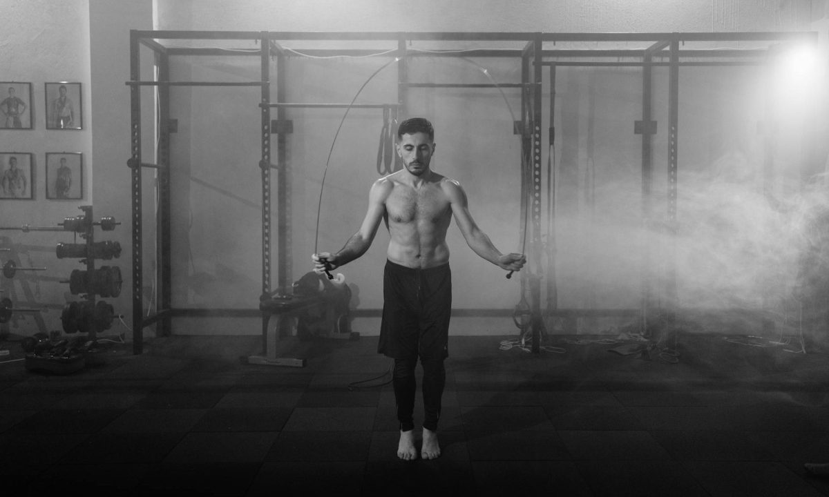 man doing jump rope black and white pic gym exercise