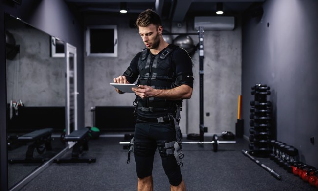 Man wearing EMS (electrical muscle stimulation) suit while working out
