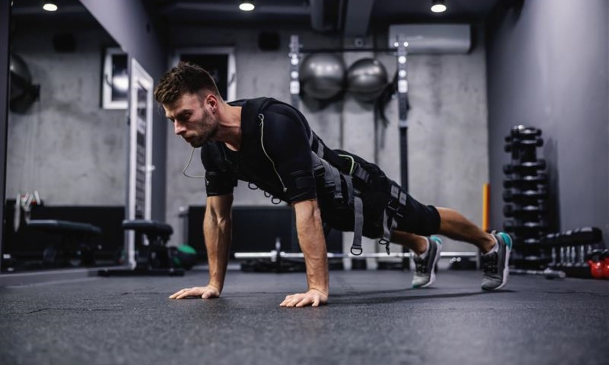 man wearing EMS suit working out push up plank press up.