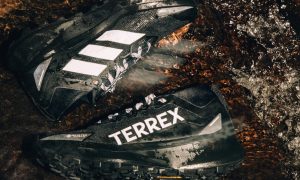Black Adidas Terrex sneakers in mud