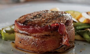 The Bacon-Wrapped Filet Mignon of Omaha Steak's Omaha Steaks Sampler on a plate.
