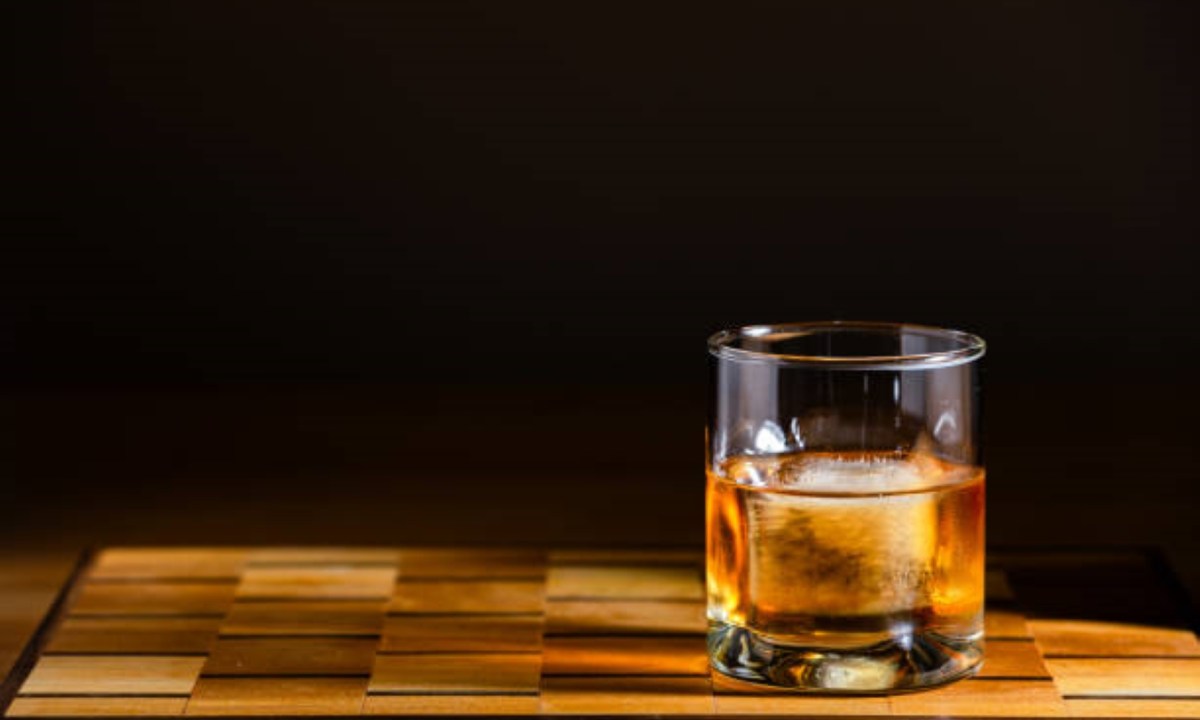Whiskey in a glass with an ice cube