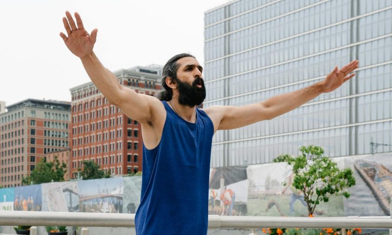 Man doing jumping jacks workout
