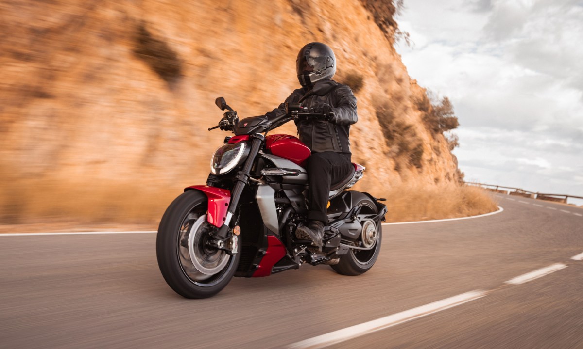 Rider on a 2025 Ducati XDiavel V4 Sport Cruiser riding on a mountain road.