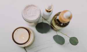 A candle and two skincare products