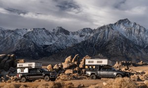 Two pickup trucks overlanding with Four Wheel Campers' CampOut truck camper installed.