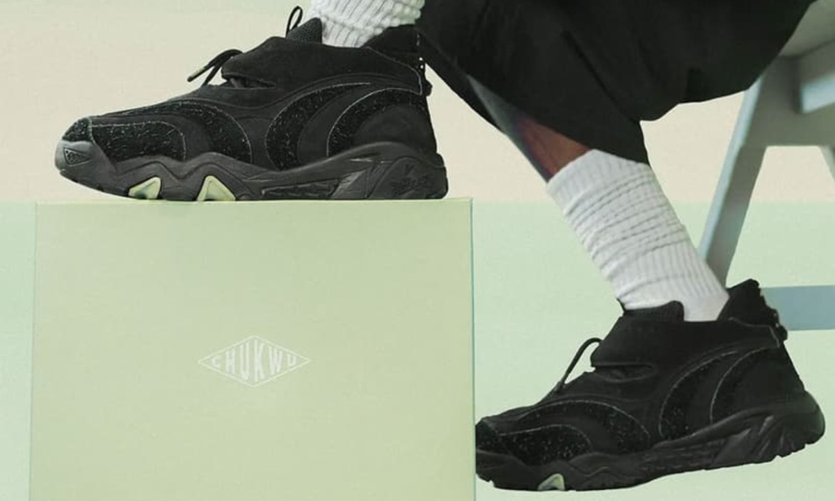 model wearing black reebok sneakers