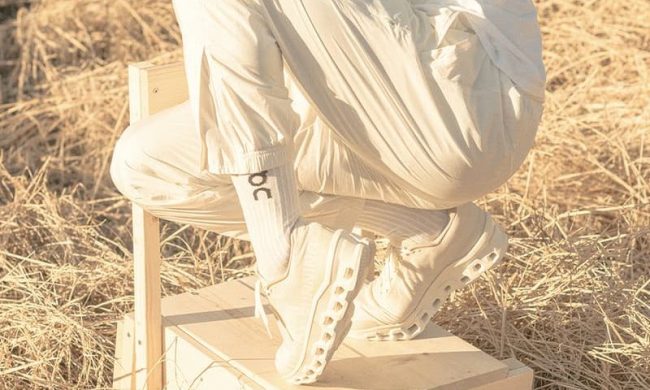 man standing on chair with white On sneakers