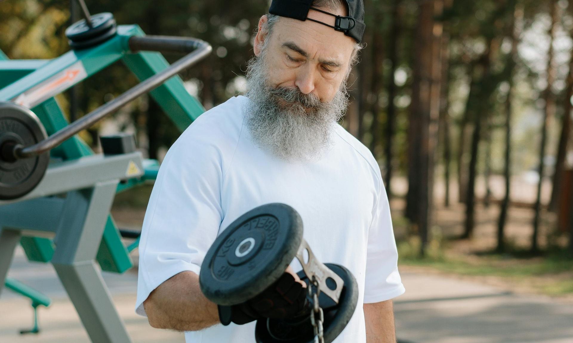 older man lifting weights bicep curl