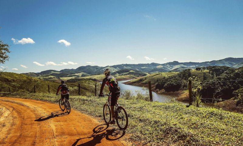 man cycling on road