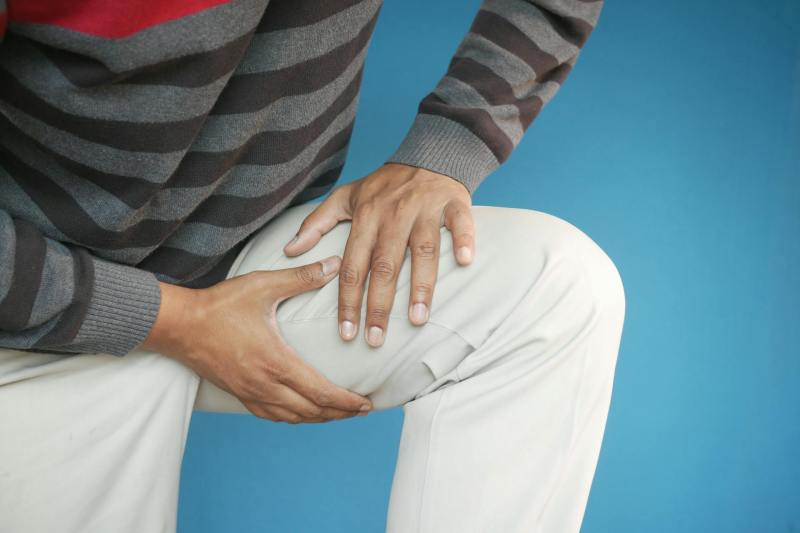 Man leg cramp holding thigh quad pain