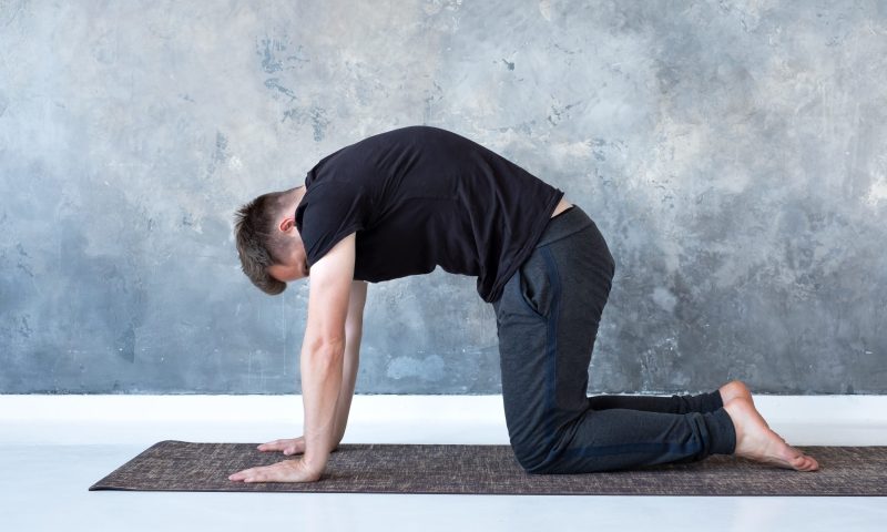 Man doing cow pose exercise yoga