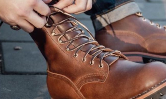 person tying laces on boots