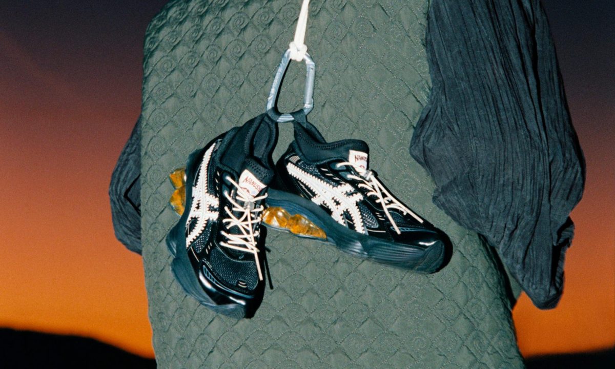 man holding sneaker over back