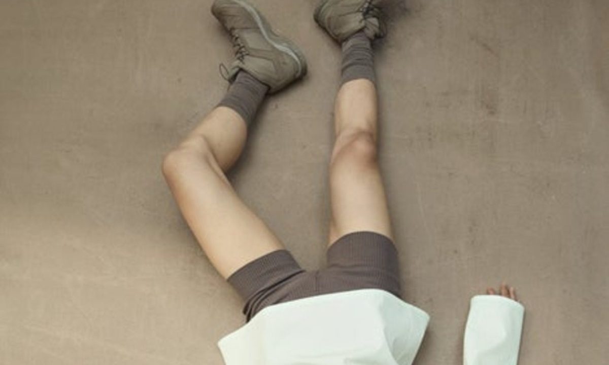 model laying down wearing salomon boot