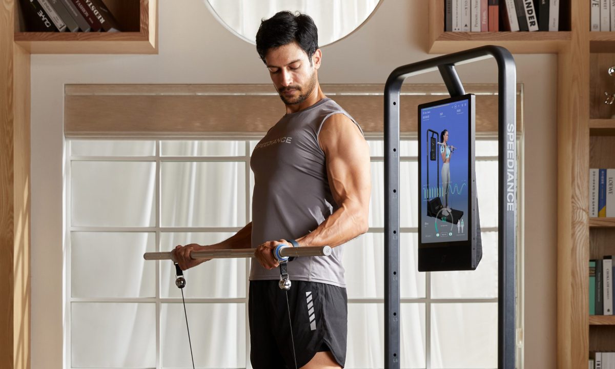 Man barbell workout at home Speediance gym machine