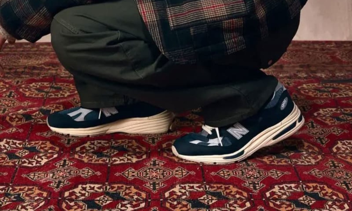 man squatting wearing new balance sneakers