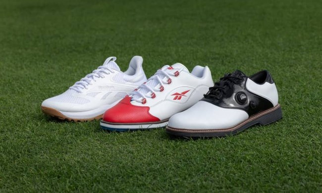 three reebok golf sneakers on green