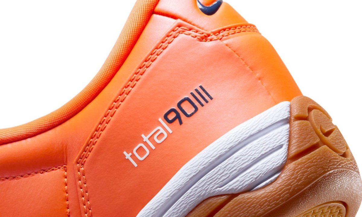 close up on nike branding on orange sneaker