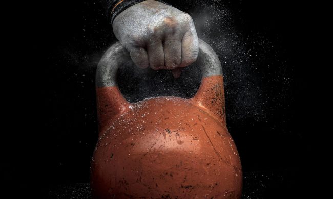 Hand holding kettlebell close up