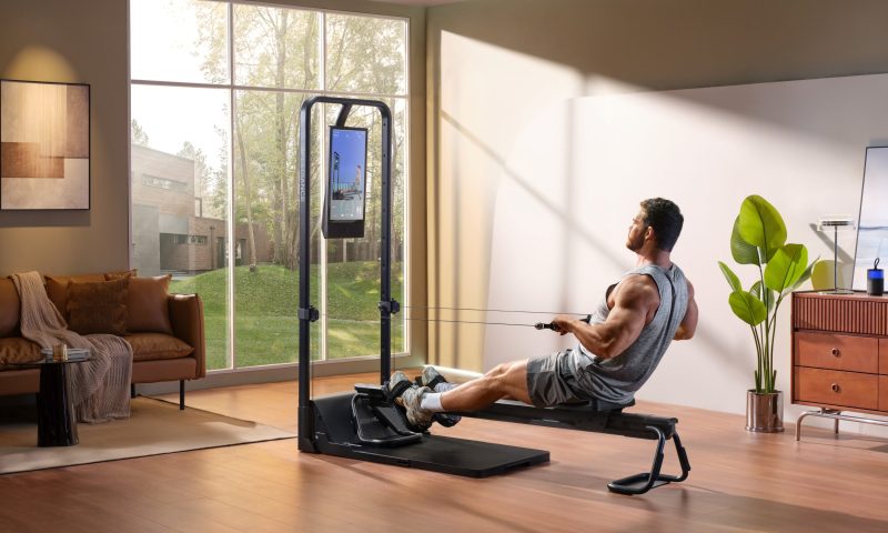man using the rowing machine on the Speediance home gym