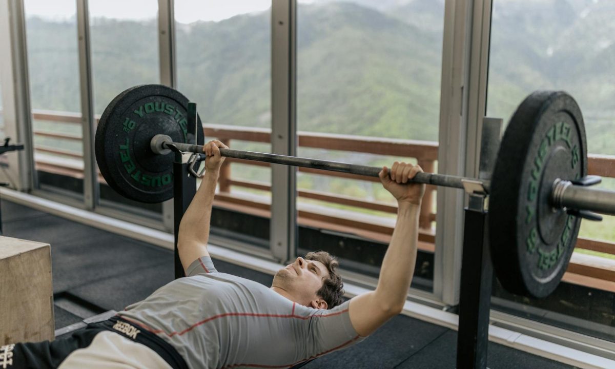 man bench press with barbell in gym
