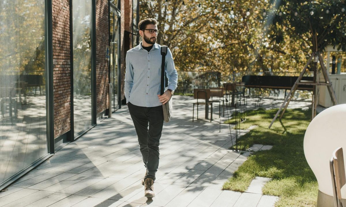 man walking outside wearing glasses