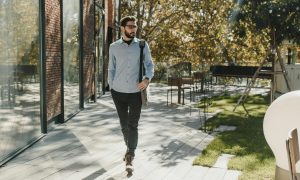 man walking outside wearing glasses