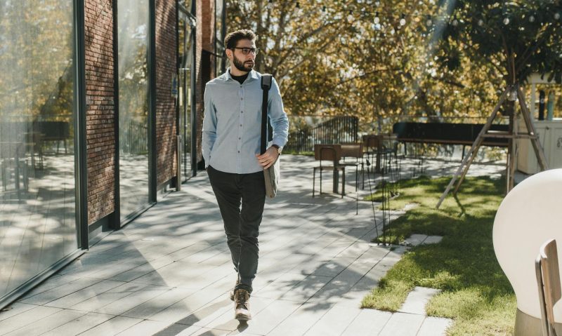man walking outside wearing glasses