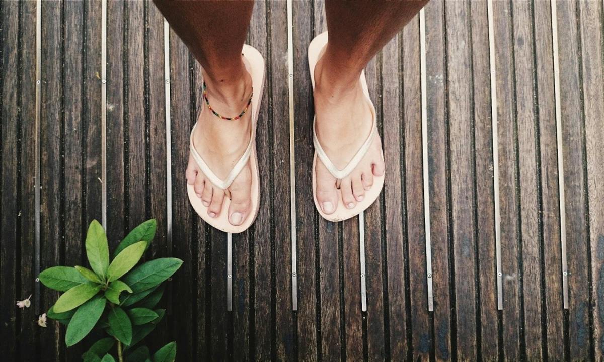 man feet close up wearing flip flops