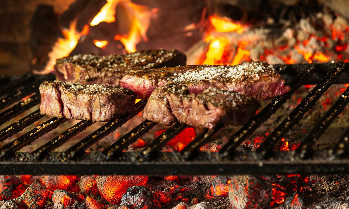 steak sizzling on a fire grill dinner