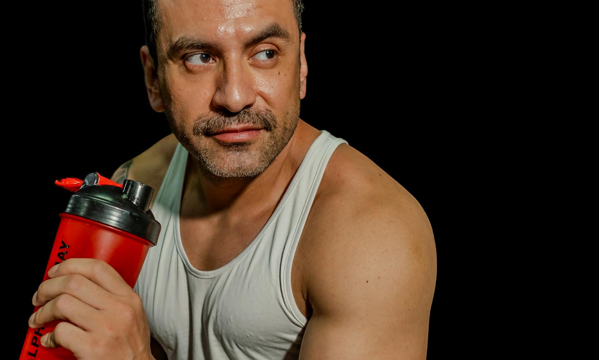 man sitting down with protein shake