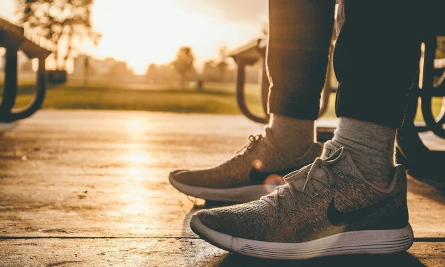 Running shoes sneakers outside park bench sunrise sunset