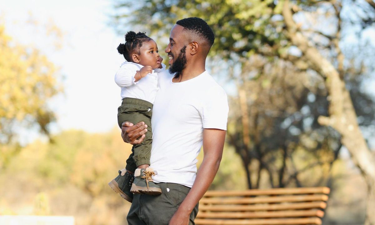 Man happy smiling holding his child